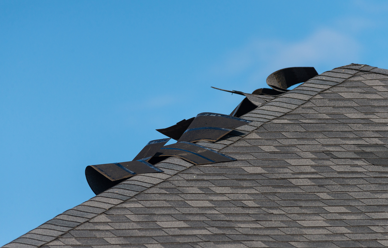 Edge of a residential roof showing significant damage